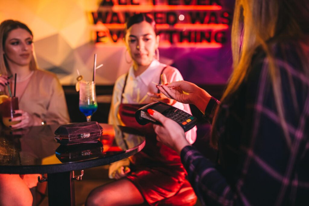 nightclub payment processing customer paying with card at busy venue
