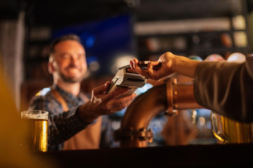 bar payment processing bartender taking card payment at counter