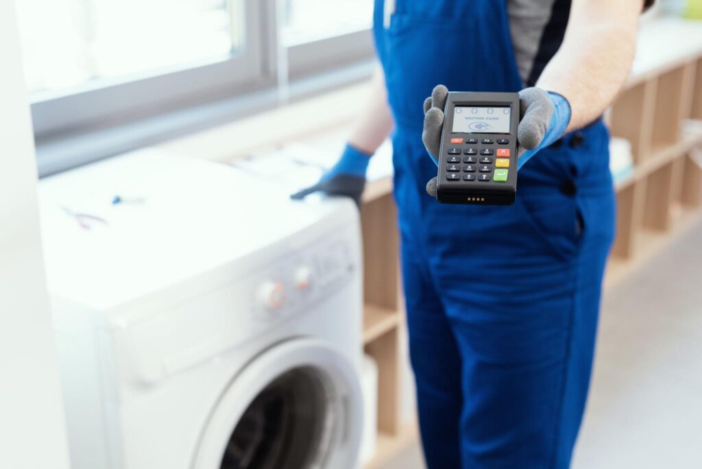 appliance repair technician accepting mobile payment at customer home
