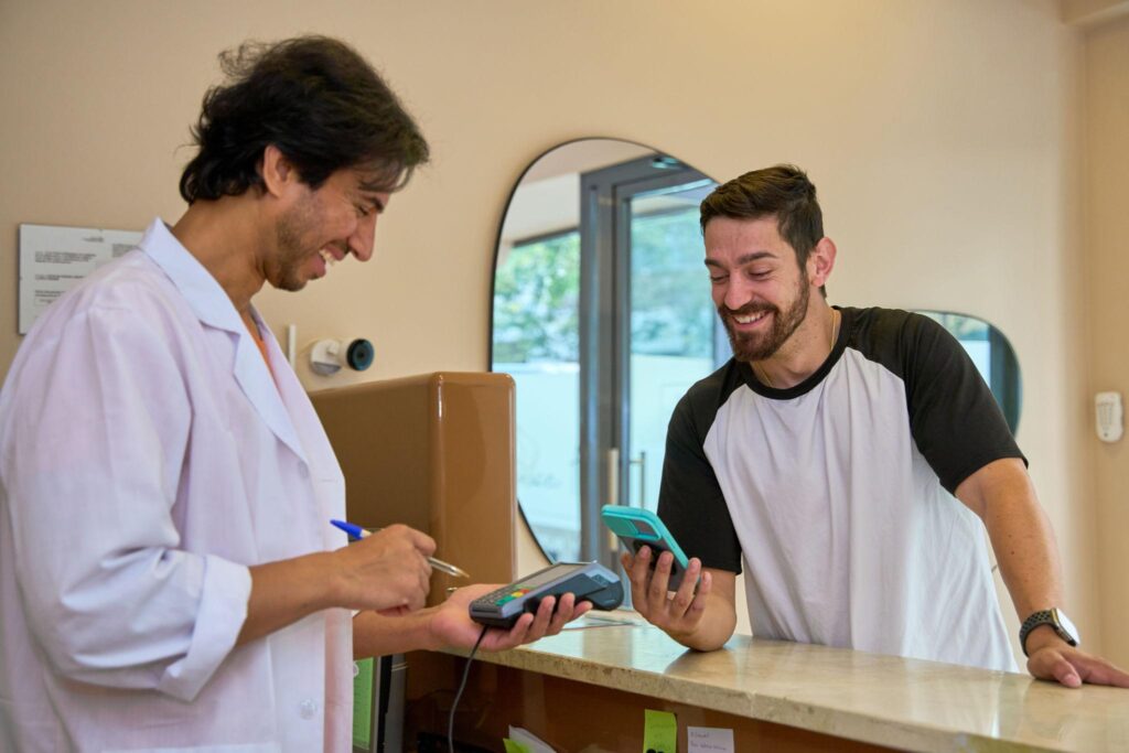 chiropractic clinic payment processing patient paying at front desk