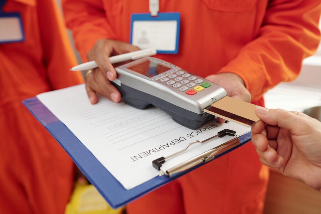 hvac technician accepting mobile payment at customer home